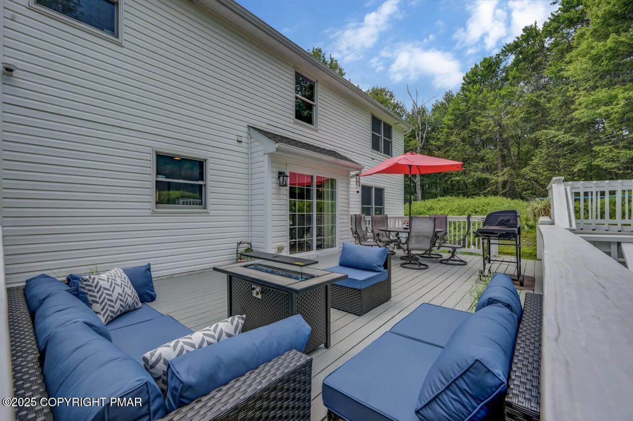 649 Snow Hill Road Cresco, PA 18326 - Photo 23 of 31 a outdoor living space with patio furniture and a umbrella