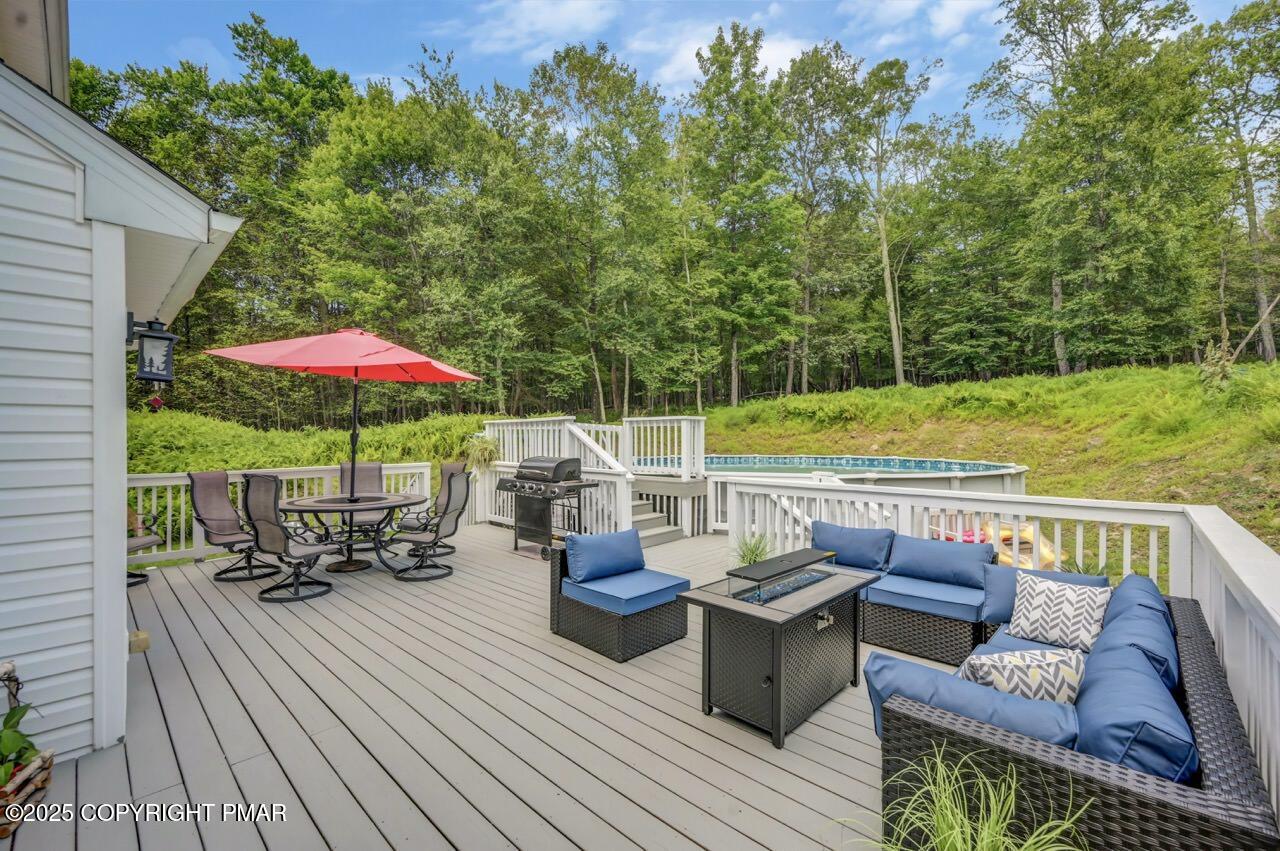 649 Snow Hill Road Cresco, PA 18326 - Photo 24 of 31 an outdoor space with furniture and umbrella