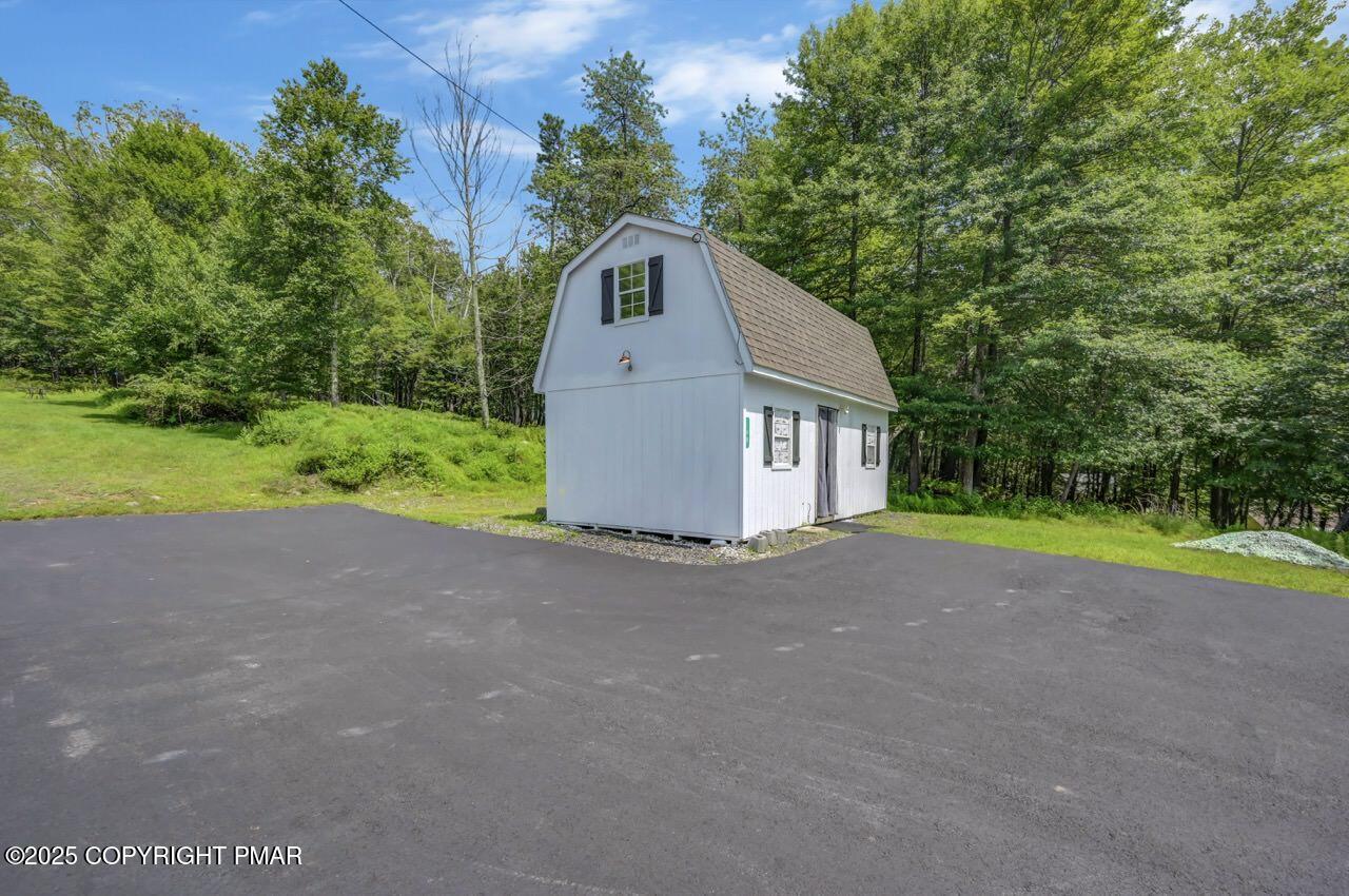 649 Snow Hill Road Cresco, PA 18326 - Photo 28 of 31 a view of a house with a yard and large tree