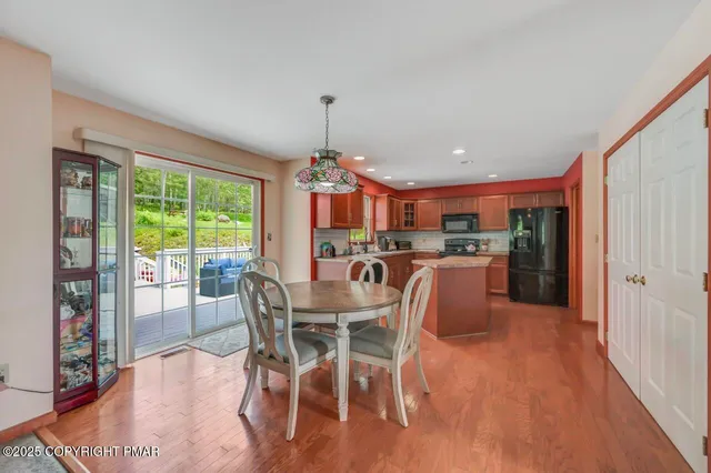 a view of a dining room with furniture window and wooden floor