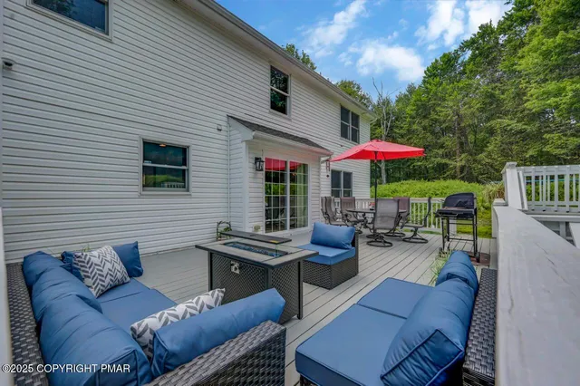 a outdoor living space with patio furniture and a umbrella