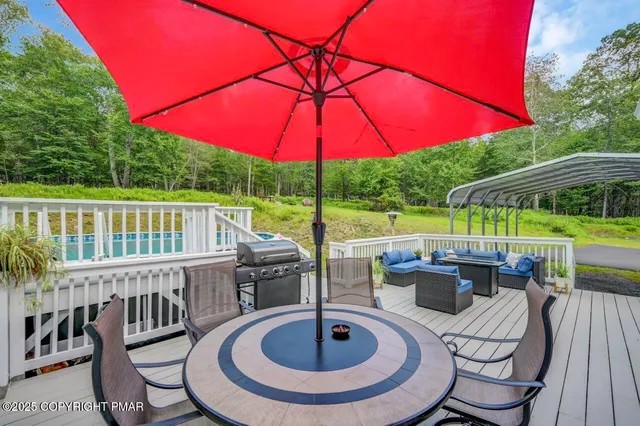 a view of a chair and table in the patio with a swimming pool