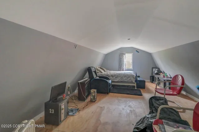 a bedroom with furniture and a window