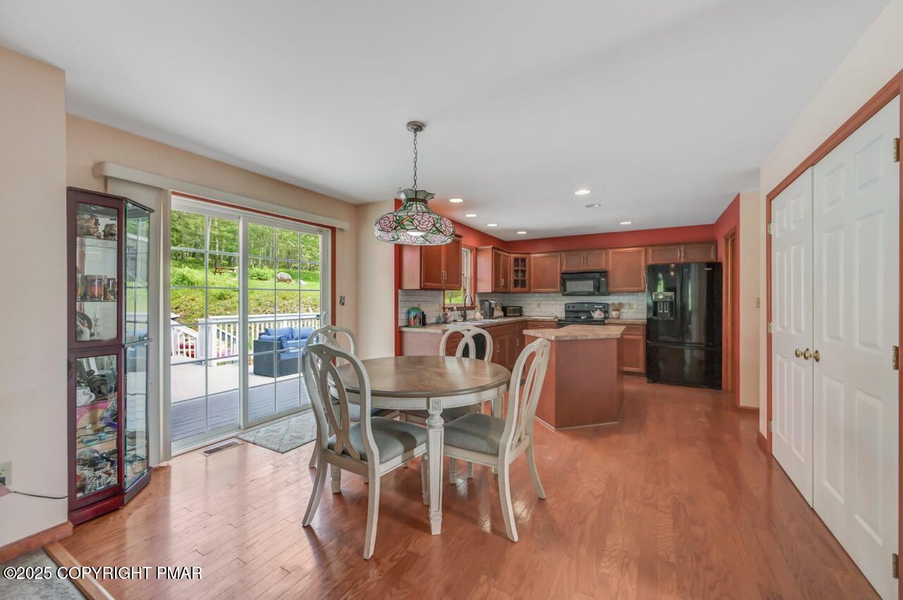 649 Snow Hill Road Cresco, PA 18326 - Photo 7 of 31 a view of a dining room with furniture window and wooden floor