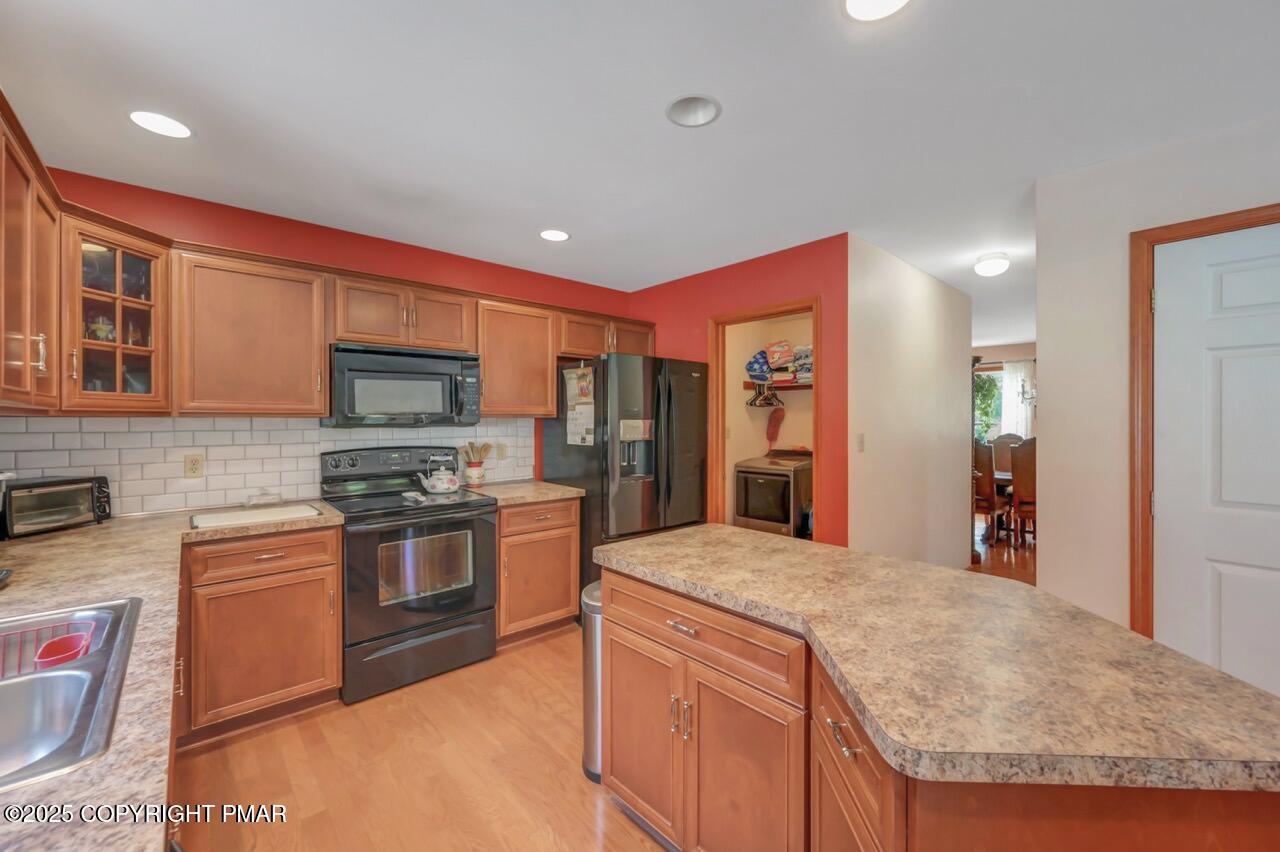 649 Snow Hill Road Cresco, PA 18326 - Photo 9 of 31 a large kitchen with stainless steel appliances granite countertop a stove and a sink