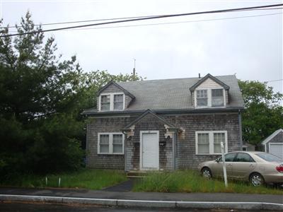 41 Spring Street, Unit 12 Hyannis, MA 02601 - Photo 1 of 11 a front view of a house with a yard and garage