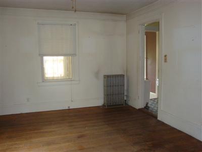 41 Spring Street, Unit 12 Hyannis, MA 02601 - Photo 3 of 11 an empty room with wooden floor and windows