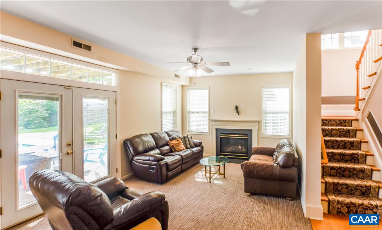 5372 Windy Ridge Road Charlottesville, VA 22903 - Photo 5 of 41 a living room with furniture a fireplace and a large window