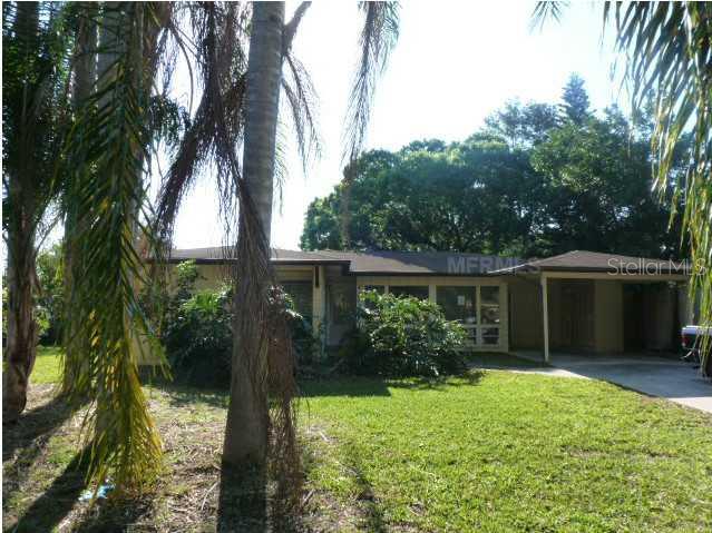 4452 Deer Ridge Place Sarasota, FL 34233 - Photo 1 of 1 a front view of house with yard and green space