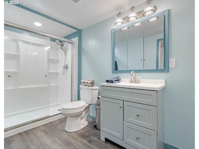 a bathroom with a sink toilet and shower