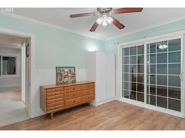 a view of a livingroom with furniture and a chandelier fan