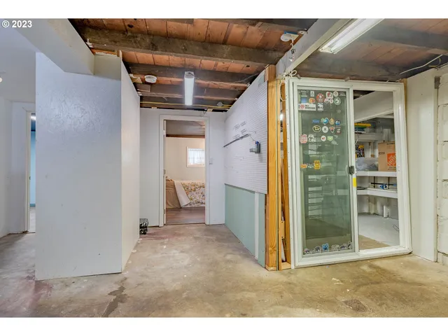 a view of a hallway with wooden shelves