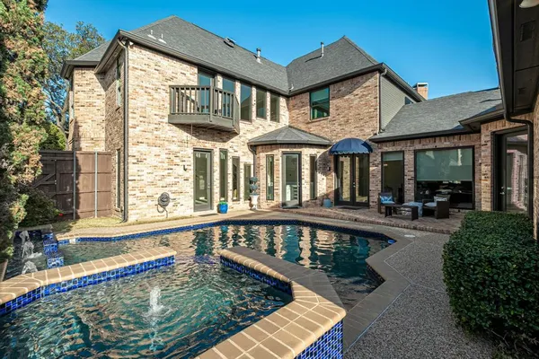 a front view of a house with swimming pool having outdoor seating