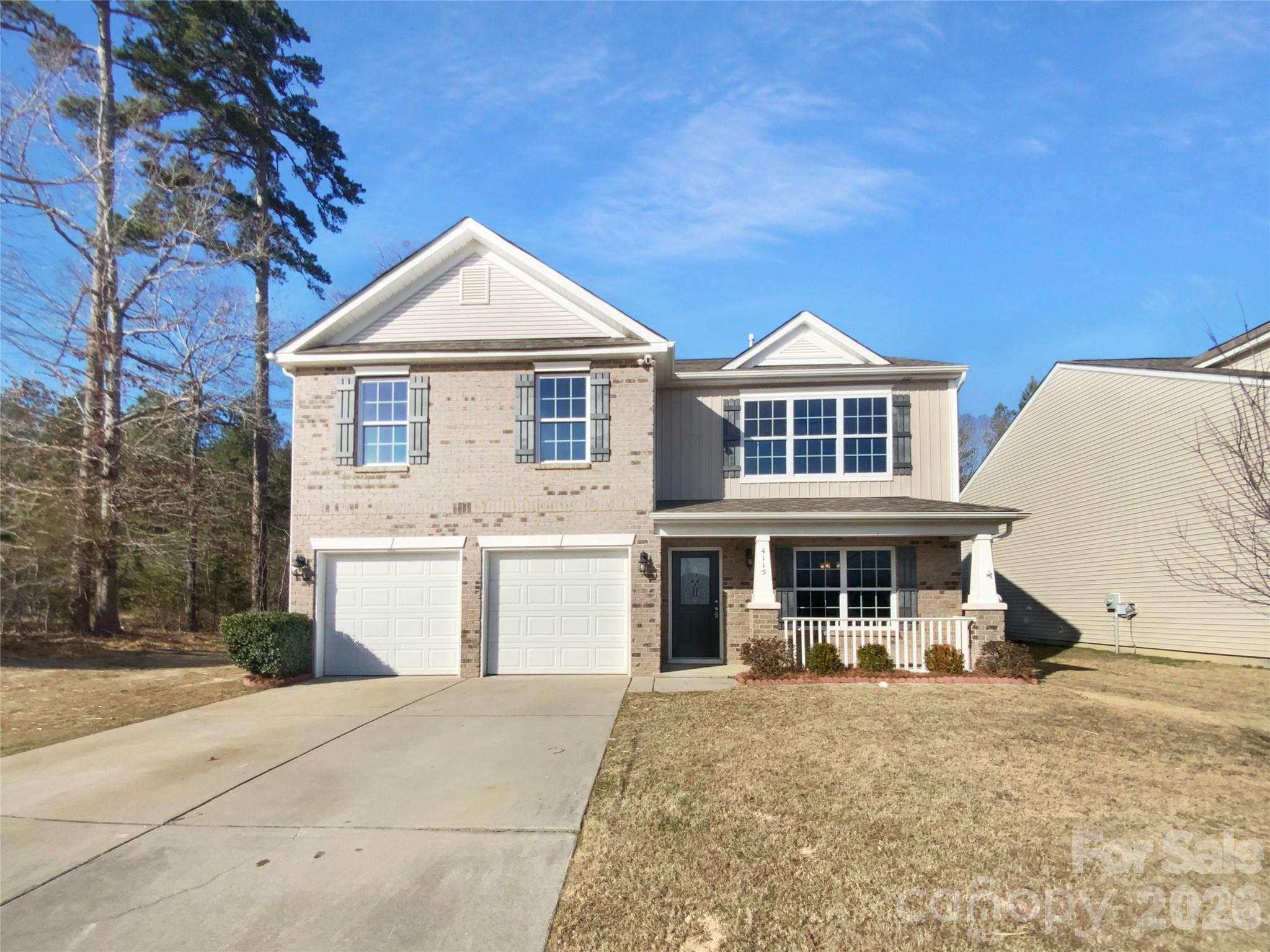 4115 Granite Street Midland, NC 28107 - Photo 1 of 25 a front view of a house with a yard and garage