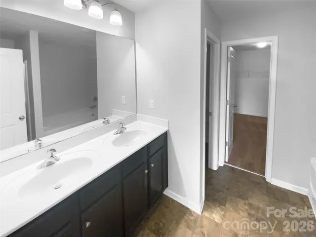 a bathroom with a double vanity sink mirror and double