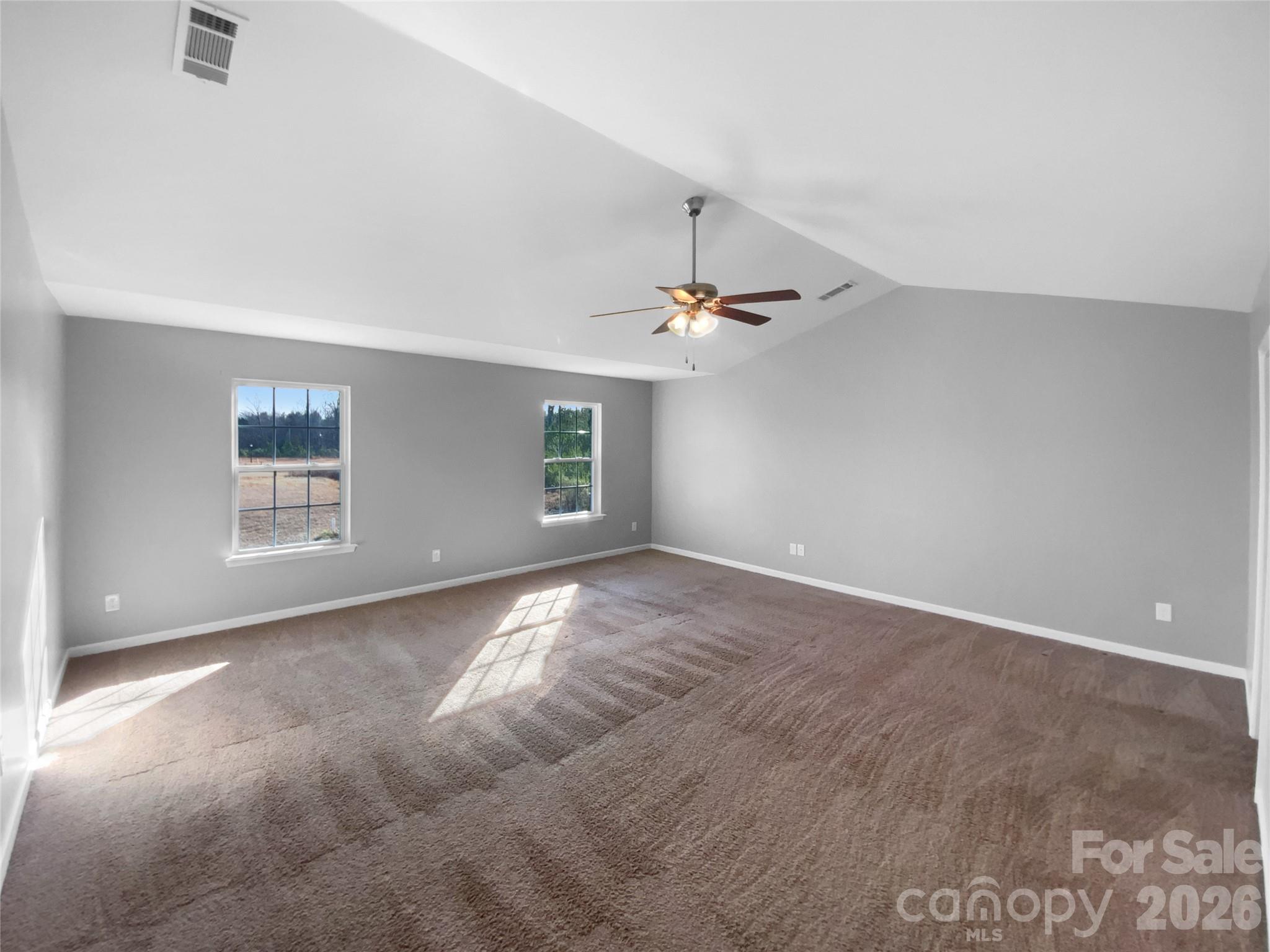 4115 Granite Street Midland, NC 28107 - Photo 13 of 25 an empty room with windows and chandelier fan