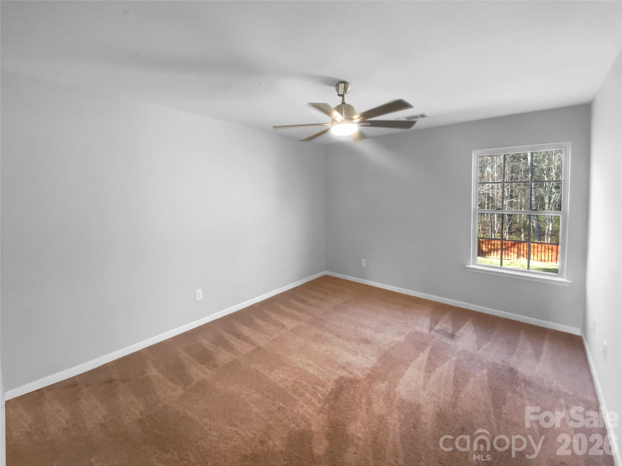 4115 Granite Street Midland, NC 28107 - Photo 14 of 25 an empty room with windows and fan