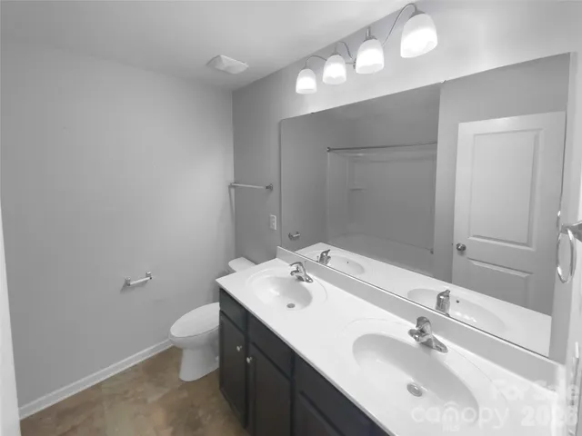 a bathroom with a double vanity sink and a mirror