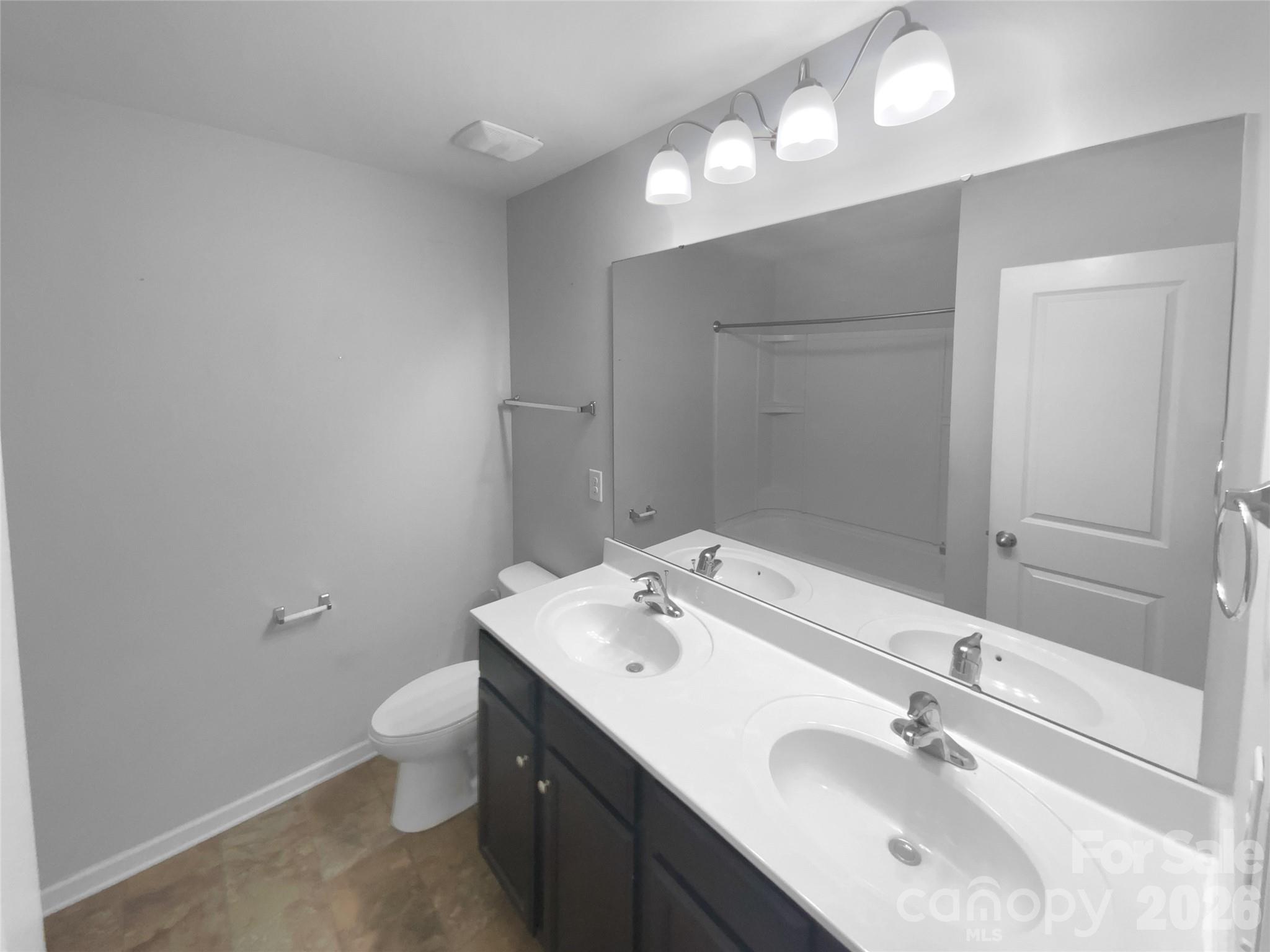 4115 Granite Street Midland, NC 28107 - Photo 16 of 25 a bathroom with a double vanity sink and a mirror
