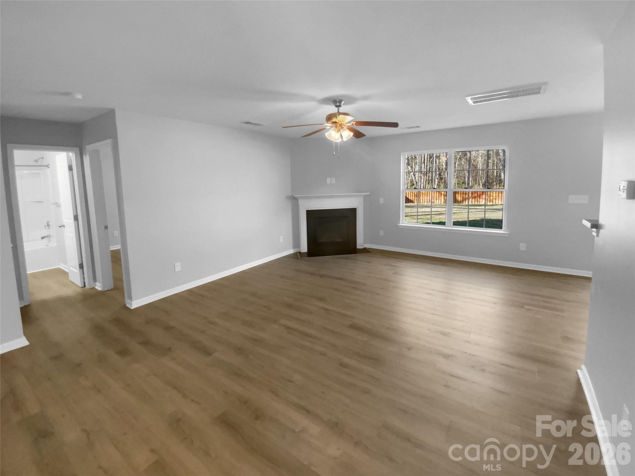 4115 Granite Street Midland, NC 28107 - Photo 3 of 25 an empty room with windows and chandelier fan