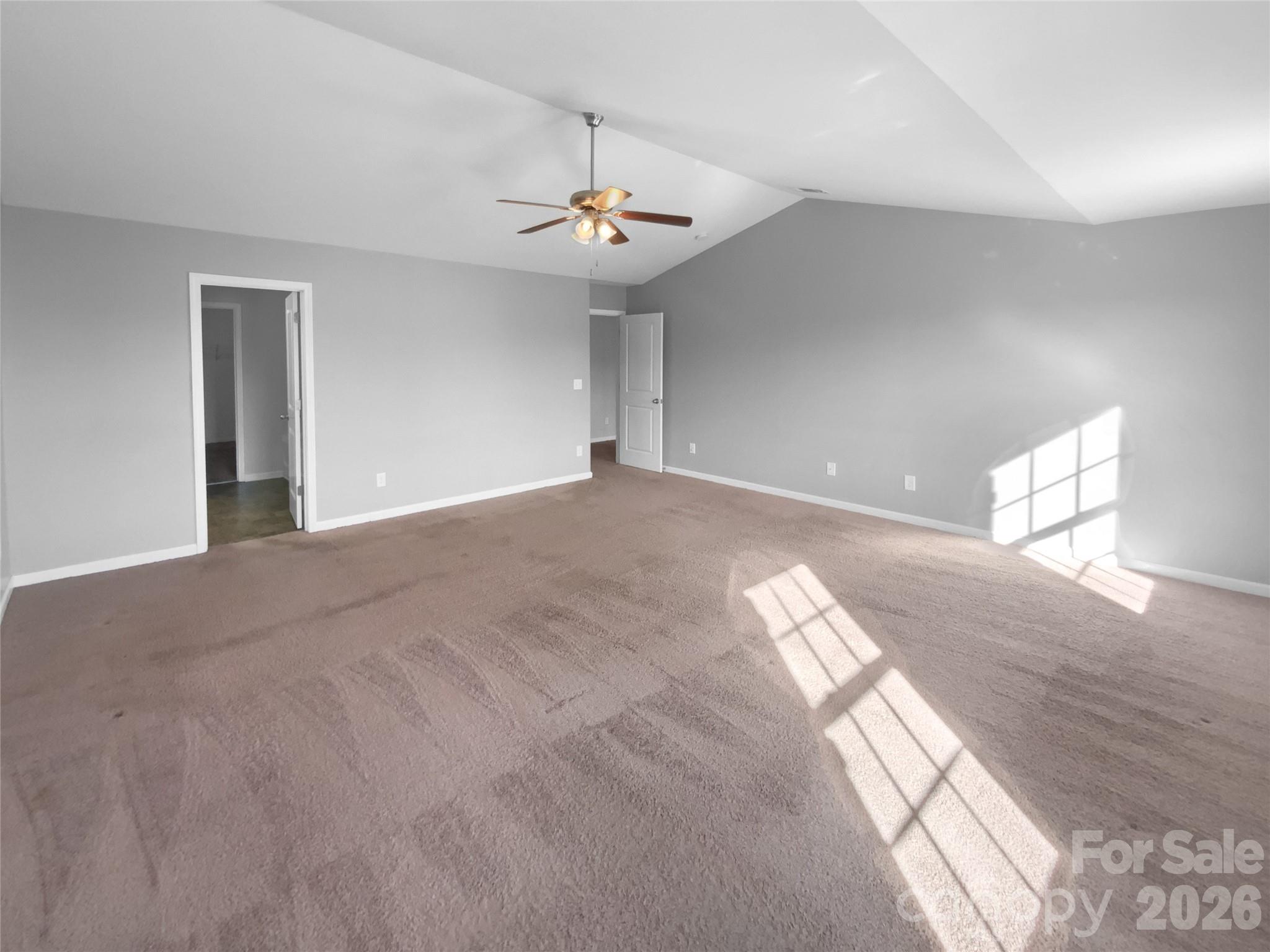 4115 Granite Street Midland, NC 28107 - Photo 4 of 25 a view of an empty room with chandelier fan and windows