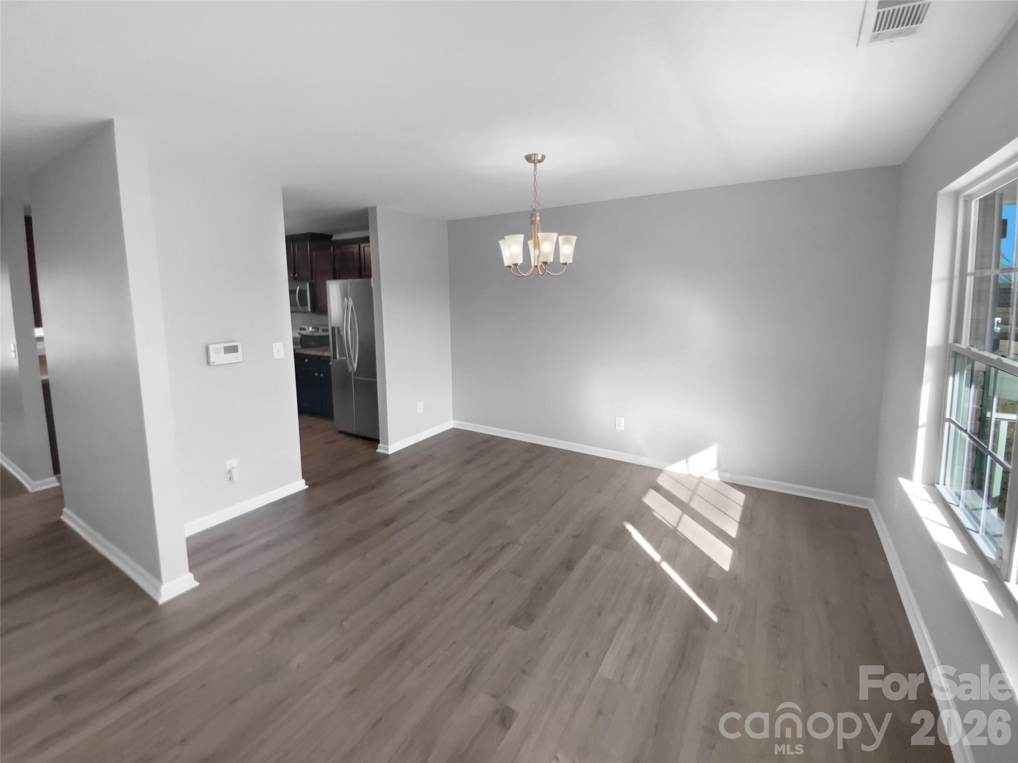 4115 Granite Street Midland, NC 28107 - Photo 8 of 25 an empty room with wooden floor and windows