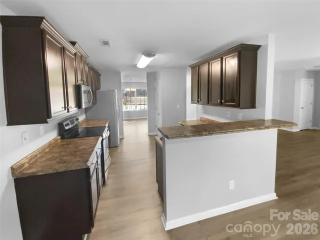 a living room with granite countertop furniture and a flat screen tv