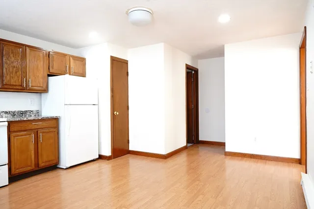 a view of an empty room with a kitchen