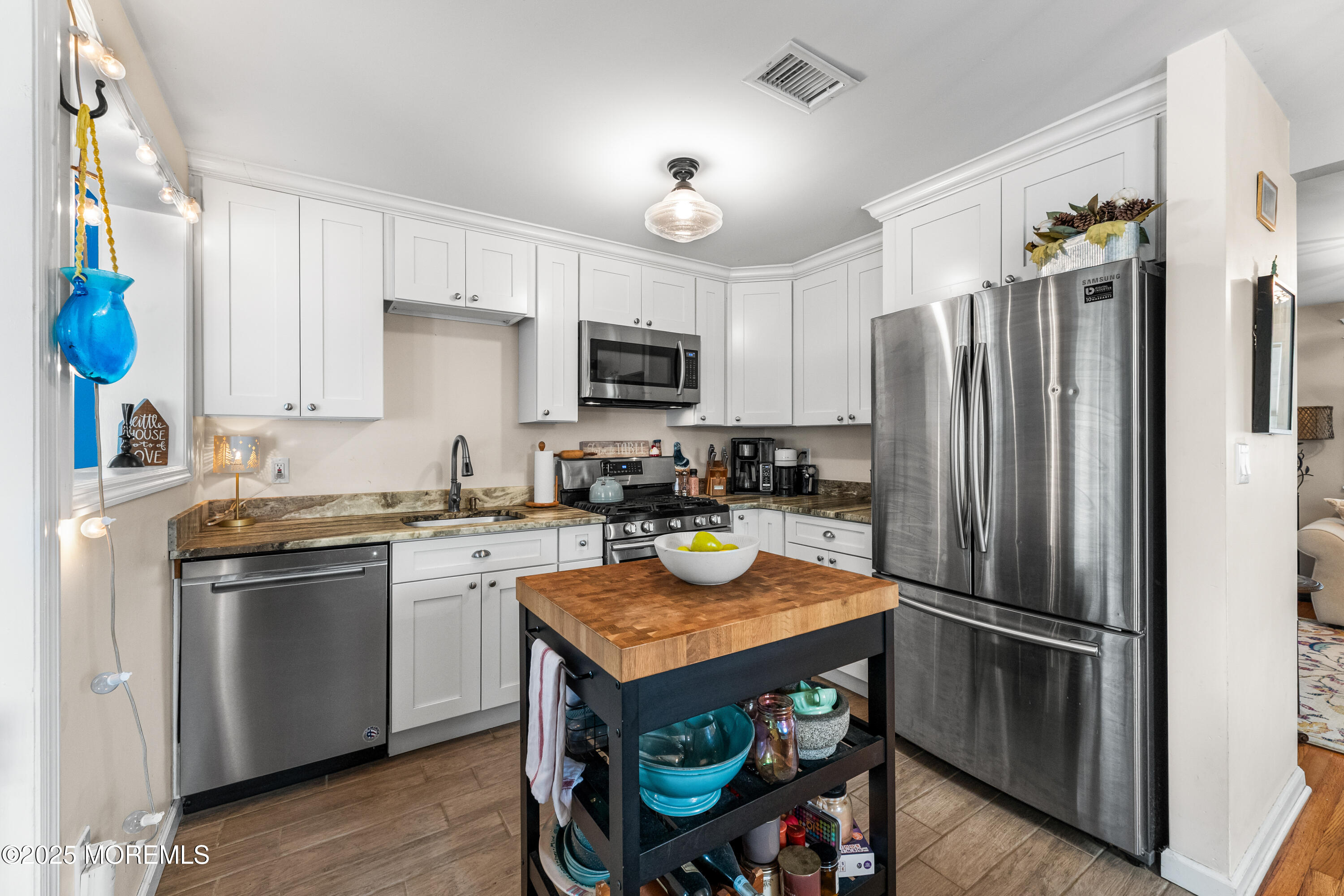 1609 Wight Street Wall, NJ 07719 - Photo 19 of 39 a kitchen with stainless steel appliances granite countertop a refrigerator a stove a sink a dining table and chairs