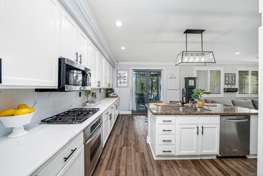 23 Wayfaire Rancho Santa Margarita, CA 92688 - Photo 3 of 44 a kitchen with a sink stove and cabinets
