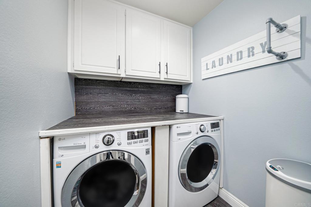23 Wayfaire Rancho Santa Margarita, CA 92688 - Photo 32 of 44 a view of washer and dryer with kitchen in the background
