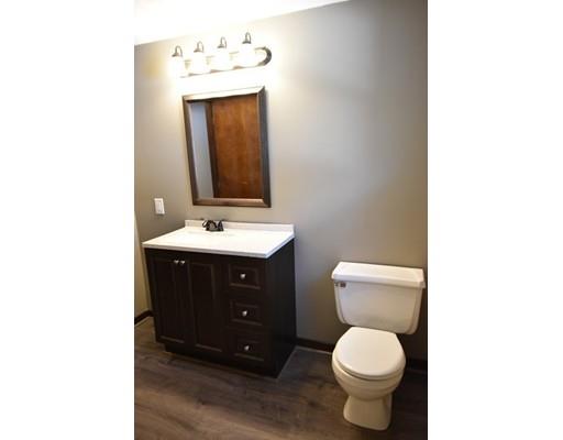 411 Southampton Road Holyoke, MA 01040 - Photo 14 of 27 a bathroom with a toilet sink and mirror