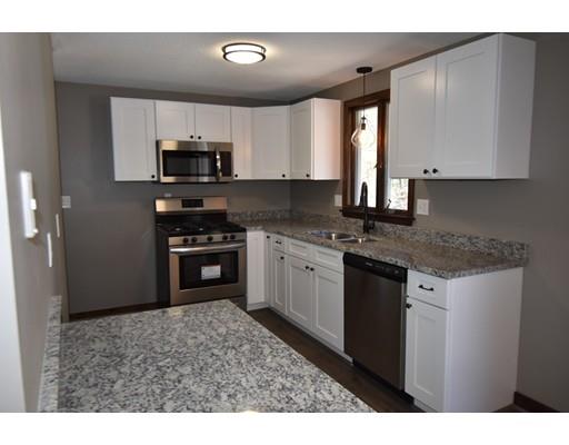411 Southampton Road Holyoke, MA 01040 - Photo 4 of 27 a kitchen with stainless steel appliances granite countertop a stove a sink and a microwave