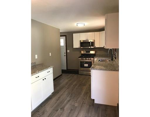 411 Southampton Road Holyoke, MA 01040 - Photo 6 of 27 a kitchen with cabinets wooden floor and stainless steel appliances