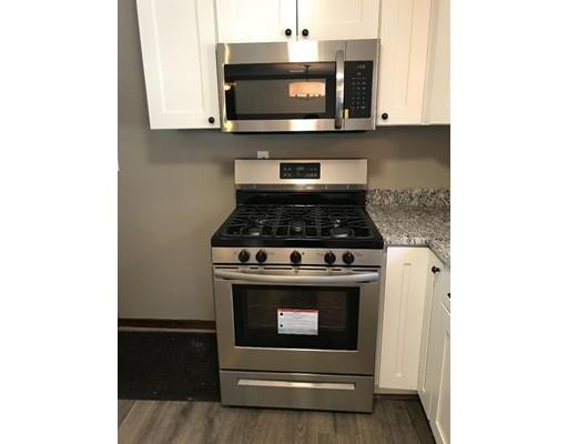 411 Southampton Road Holyoke, MA 01040 - Photo 7 of 27 a kitchen with a stove and a microwave