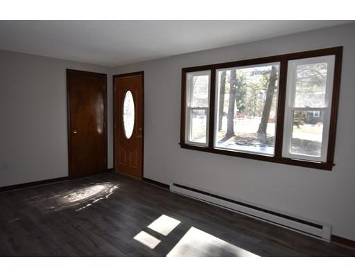 411 Southampton Road Holyoke, MA 01040 - Photo 10 of 27 a view of an empty room with wooden floor and a window
