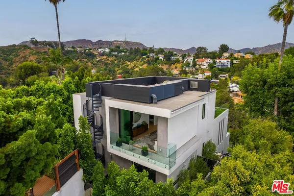 an aerial view of a house with a yard