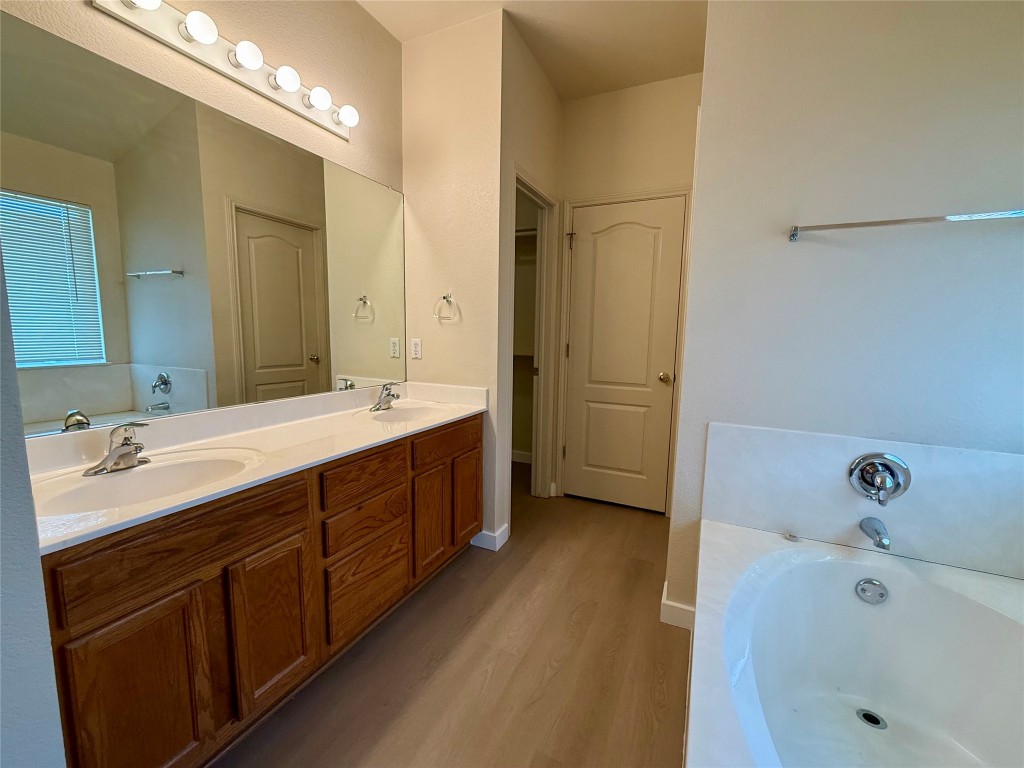 4526 Tello Path Austin, TX 78749 - Photo 13 of 24 a bathroom with a tub double sink and mirror