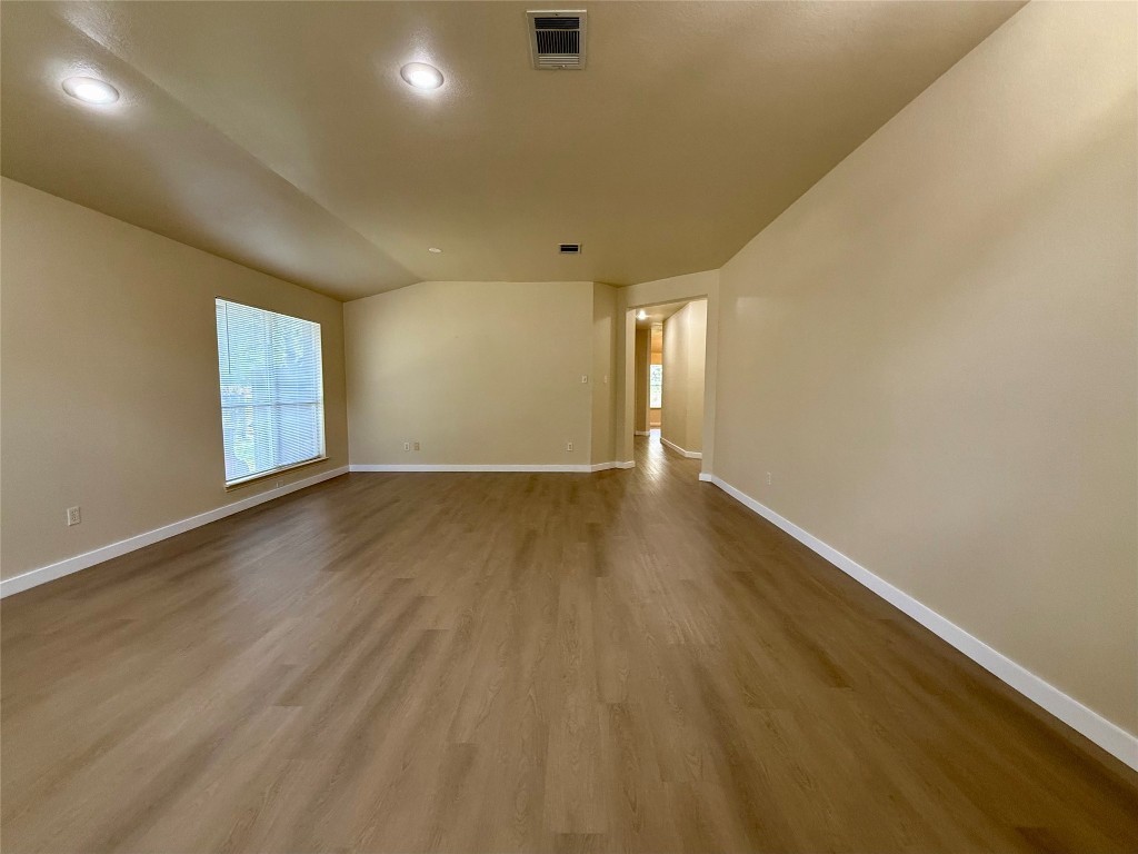 4526 Tello Path Austin, TX 78749 - Photo 3 of 24 an empty room with wooden floor and windows