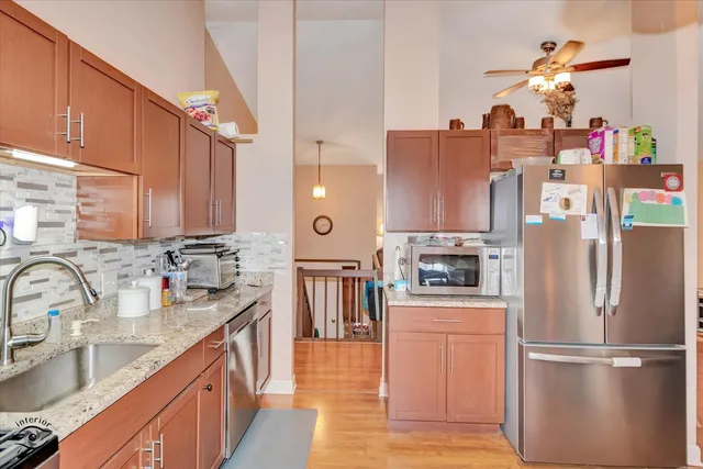 a kitchen with stainless steel appliances granite countertop a refrigerator and a sink