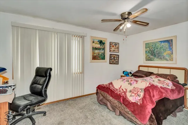 a bedroom with a bed and a chair