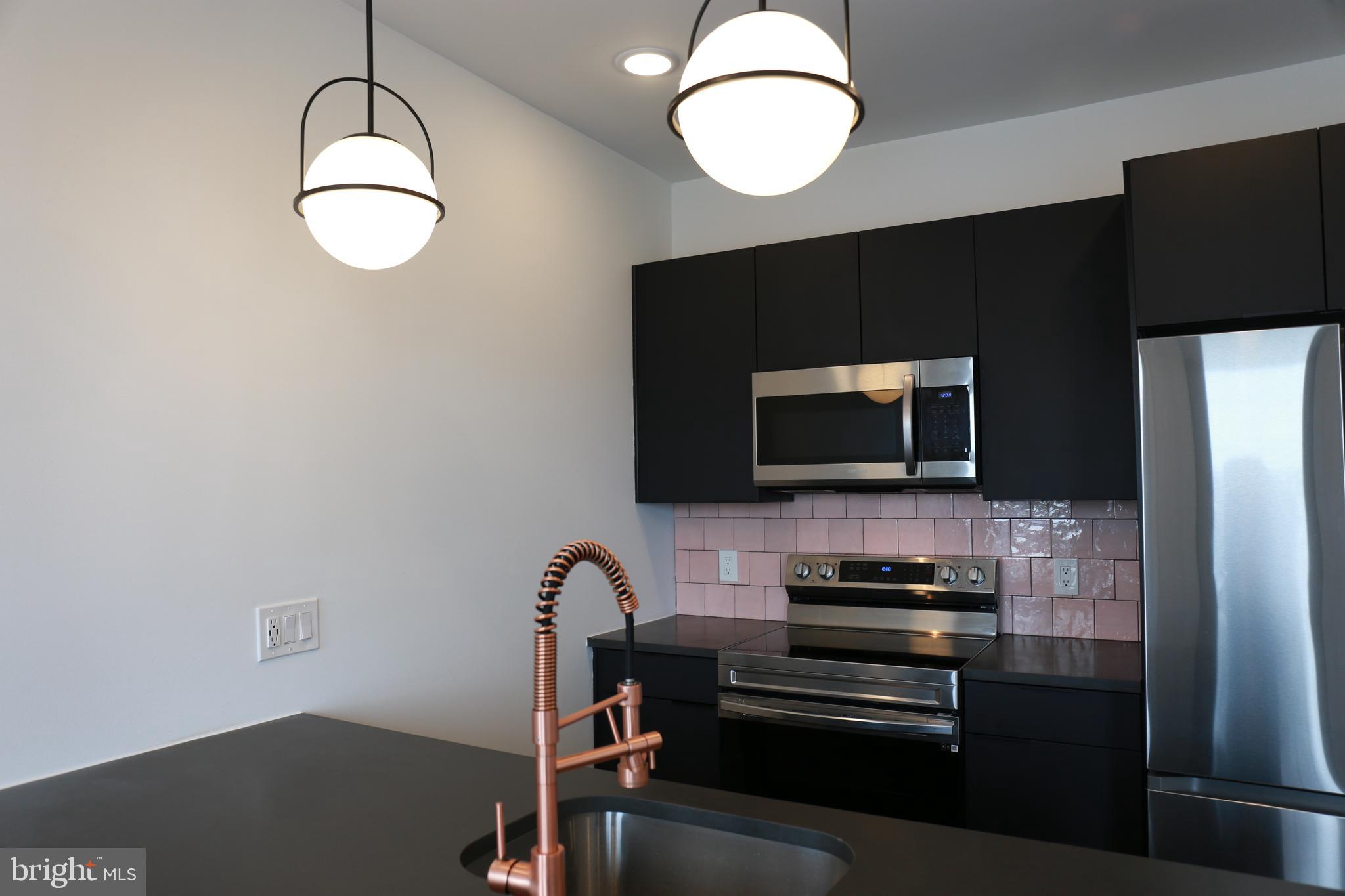 1111 South Broad Street, Unit 2BED/2BATH Philadelphia, PA 19147 - Photo 18 of 25 a kitchen with a refrigerator and a microwave