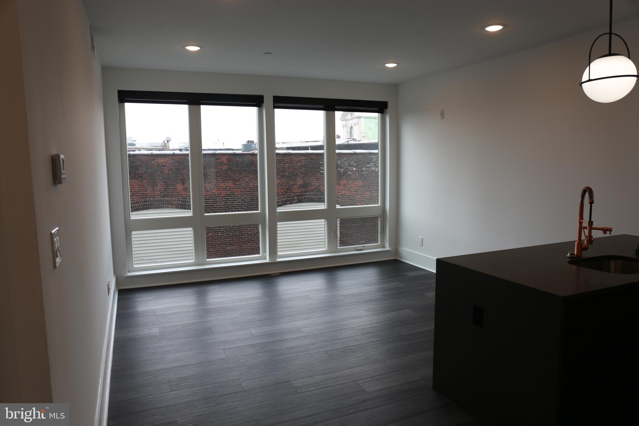 1111 South Broad Street, Unit 2BED/2BATH Philadelphia, PA 19147 - Photo 24 of 25 a view of a livingroom with wooden floor and a window