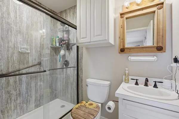 a bathroom with a toilet sink and shower