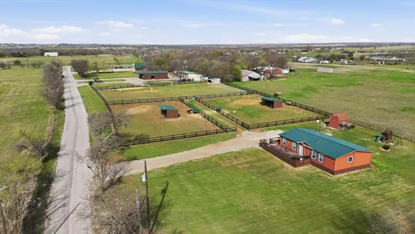 an aerial view of a house with a yard