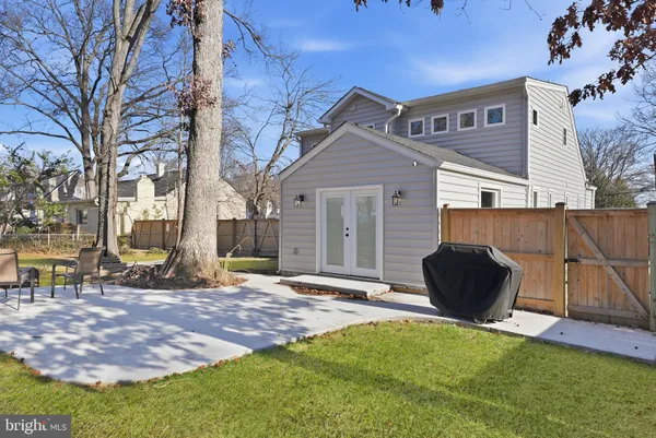 a backyard of a house with table and chairs