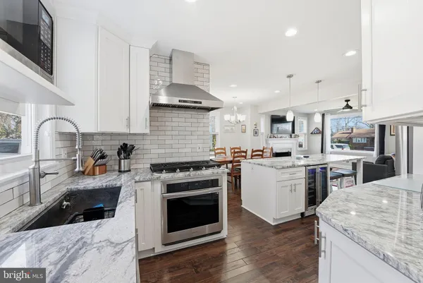 a kitchen with a stove sink and cabinets