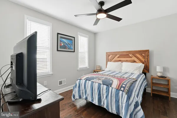 a bedroom with a bed tv and a flat screen tv