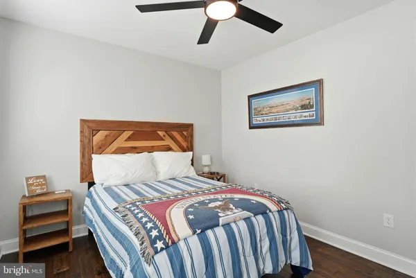 a bedroom with a bed and a painting on the wall