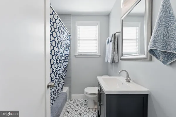 a bathroom with a sink toilet and window